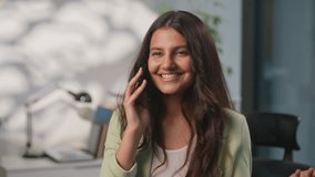 Smiling carefree Indian informal business woman enjoying conversation talking mobile phone at office joyful Arabian female girl businesswoman talk smartphone virtual communication hindu lady chat - Powered by Shutterstock - Get 15% off with code: PIKWIZARD15