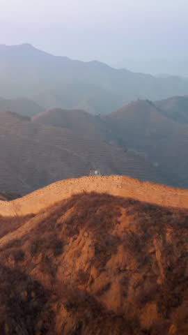 Flying over the Great Wall of China at sunrise. Vertical Video,