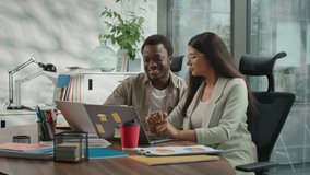 Two multiethnic business people informal team in office working laptop talking African American businessman Hindu businesswoman looking computer monitor male mentor helping female intern assistance - Powered by Shutterstock - Get 15% off with code: PIKWIZARD15