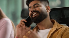 Arabian man informal business guy Hindu businessman Indian male professional talking mobile phone negotiating communicate with smartphone call in office team meeting discuss ideas working in company - Powered by Shutterstock - Get 15% off with code: PIKWIZARD15