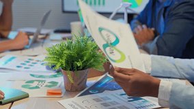 During an office night meeting, multi-ethnic business people intensely brainstorm and focus on paperwork to define goal strategy for a pivotal ESG business shift and agile transformation driving goal - Powered by Shutterstock - Get 15% off with code: PIKWIZARD15