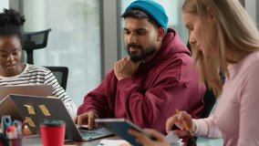 Three concentrated informal business diversity people together team focused indoor in office Indian pensive man with laptop thinking Caucasian female writing notes African American woman with computer - Powered by Shutterstock - Get 15% off with code: PIKWIZARD15