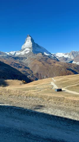 Take the Gornergrat Railway from Zermatt to the summit, with views of the autumnal landscape. Beautiful Swiss mountain scenery.