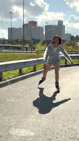 Caucasian woman rollerblading fast on road. 