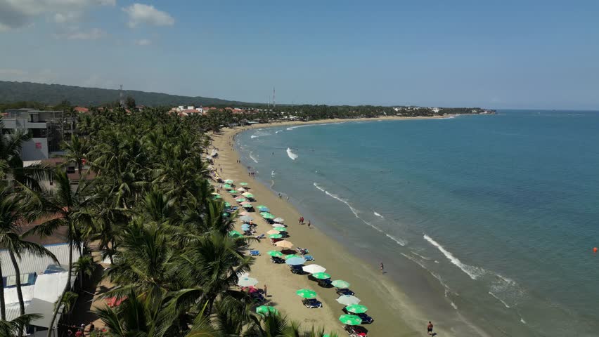 Drone orbit over Cabarete coastline with sand, surf, and open horizon. Ideal for tourism videos and cinematic establishing shots