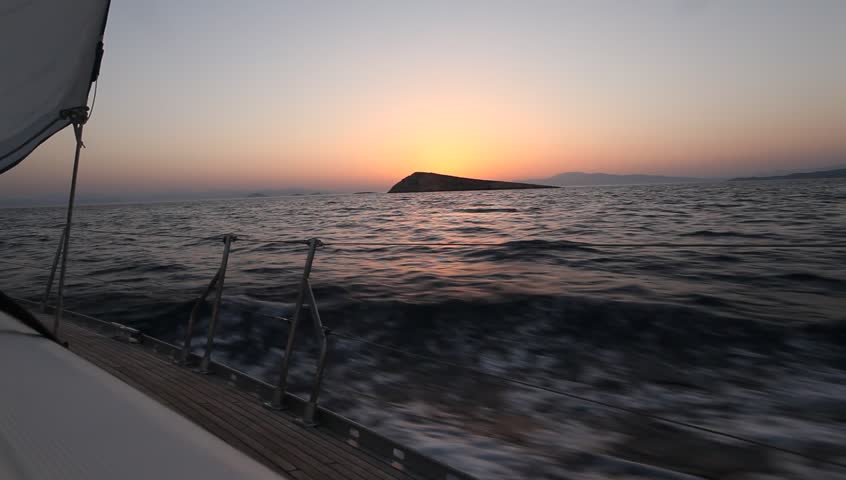 Sailing through the waves in the Aegean Sea during sunset (HD) Sailing boat shot