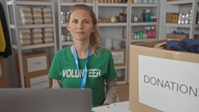Woman wearing a lanyard is pointing inside a warehouse where a blonde young volunteer arranges a donation box on shelves. - Powered by Shutterstock - Get 15% off with code: PIKWIZARD15