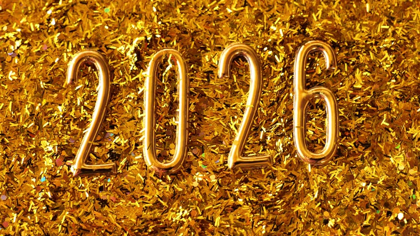 New Year and Christmas symbol golden wallpaper. 2026 gold background. Gold glitter scatters around the number two thousand twenty six.Shining glitter gold festive background. 4k footage