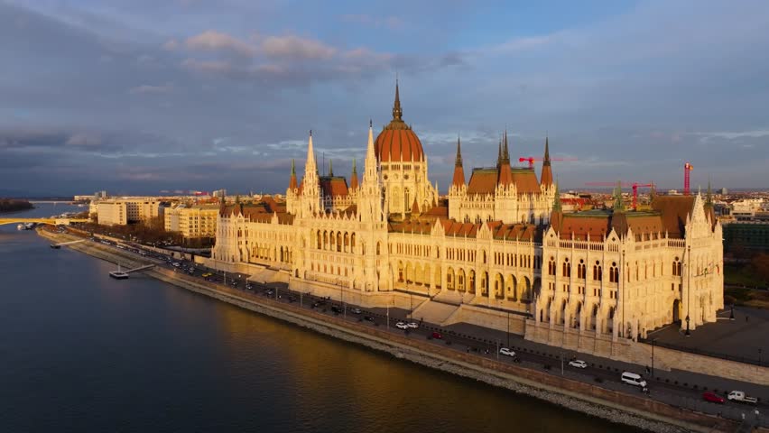 4K Spectacular drone footage of the Hungarian Parliament Building on the banks of the Danube River in Budapest at golden hour. Hungary019