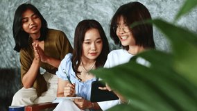 Group of Indonesian teenagers collaborating while studying in cafe, using tablet and taking notes, with hearing impaired student engaging through sign language communication - Powered by Shutterstock - Get 15% off with code: PIKWIZARD15