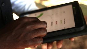 Businessman reviewing stock market data and financial charts on a tablet, possibly discussing investment strategies or business performance  - Powered by Shutterstock - Get 15% off with code: PIKWIZARD15