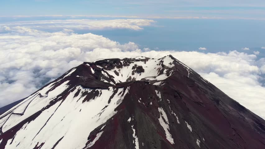 Aerial Drone Flyover of Mount Fuji Crater and Snow Capped Peak, Japan