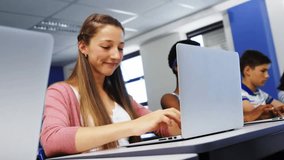 Teenage student typing on laptop in computer lab spawning profile chat icons networking classmates. Technology, connectivity, education, digital, interface, innovation, teamwork - Powered by Shutterstock - Get 15% off with code: PIKWIZARD15