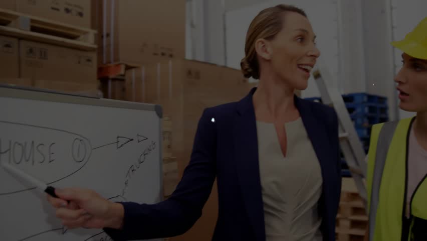 Warehouse manager pointing at whiteboard and initiating network overlay visualizing workflows. Industrial, teamwork, logistics, digital, collaboration, corporate, modern - Powered by Shutterstock - Get 15% off with code: PIKWIZARD15