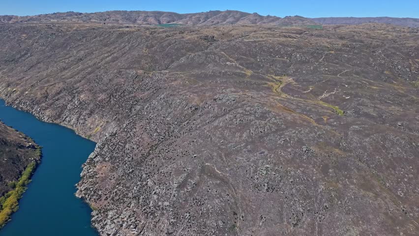 Clutha River winding through rugged landscape in Central Otago, New Zealand
