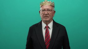 Senior man in a suit with a gold crown mimicking binoculars with his hands against a green background, creating a playful and humorous business-themed visual. - Powered by Shutterstock - Get 15% off with code: PIKWIZARD15