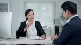 Professional businesswoman explaining job details to businessman during interview, sitting at desk in modern corporate workspace with collaborative atmosphere - Powered by Shutterstock - Get 15% off with code: PIKWIZARD15