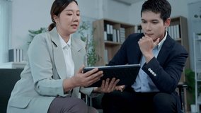 Professional business partners reviewing data on digital tablet, collaborating closely and discussing strategic project details in contemporary office workspace - Powered by Shutterstock - Get 15% off with code: PIKWIZARD15