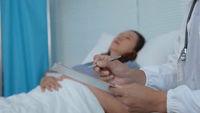 Attentive medical professional documenting patient health details during prenatal hospital consultation, providing comprehensive care for expecting mother - Powered by Shutterstock - Get 15% off with code: PIKWIZARD15