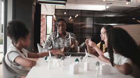 Black female teacher teaches and instructs primary girls group students, clean energy lesson at learning table in science classroom, discusses experiment knowledge for children of elementary school. - Powered by Shutterstock - Get 15% off with code: PIKWIZARD15