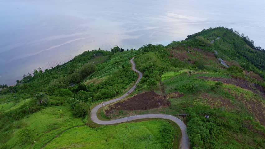 Scenic View of Green Hills by the Sea