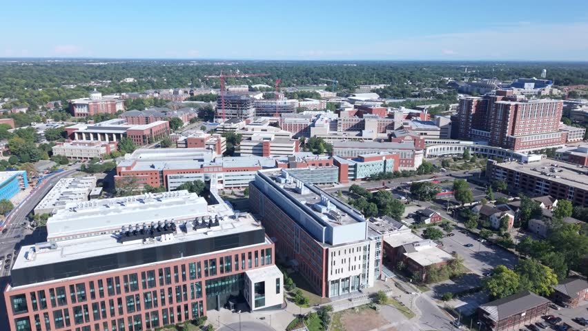 The University of Kentucky college campus and surrounding neighborhood in Lexington - daytime aerial parallax in summer