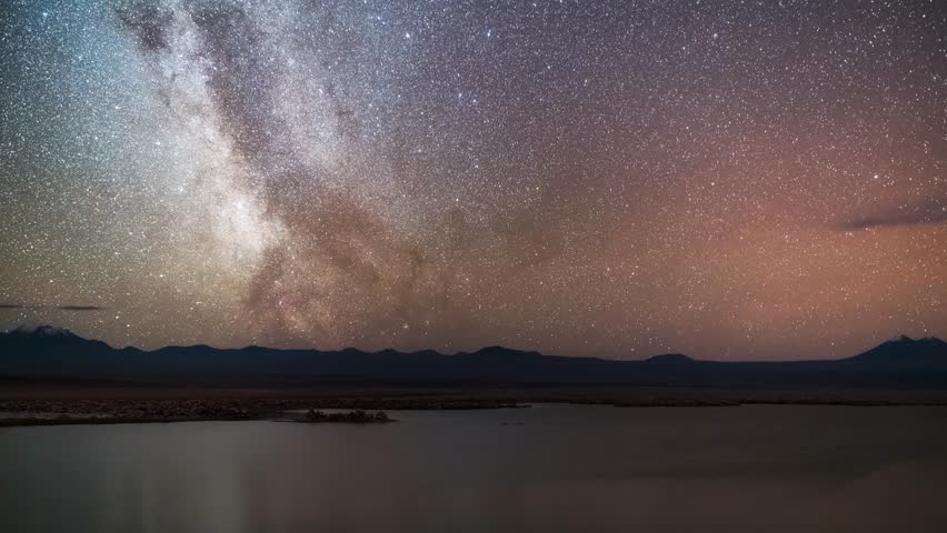 Stunning Milky Way galaxy stretching across starry night sky above tranquil mountain lake with perfect reflection, creating magical astrophotography scene