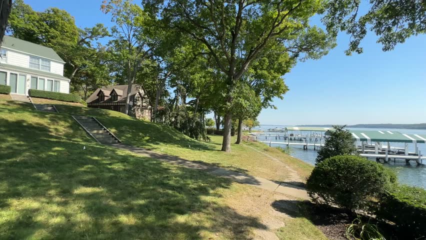 Peaceful lakeside path with trees and docks around Lake Geneva, WI