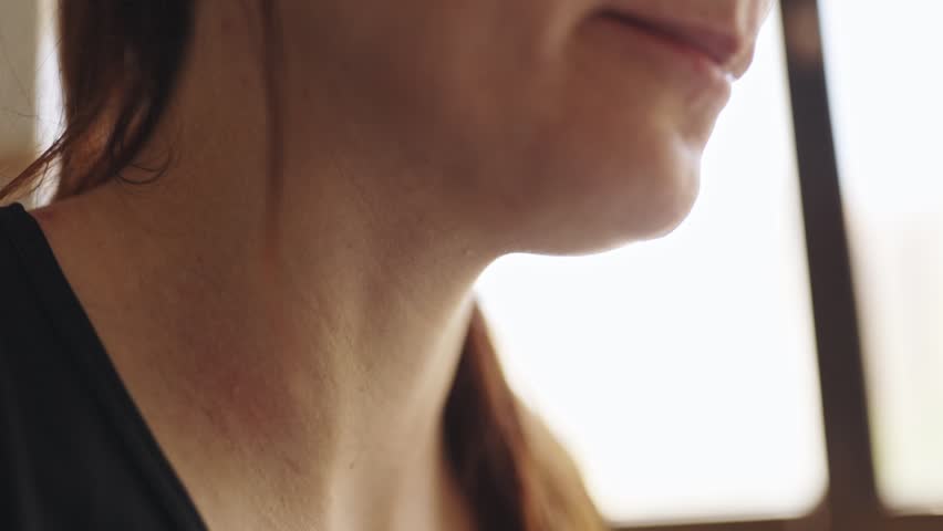 Woman eating food with a spoon close up