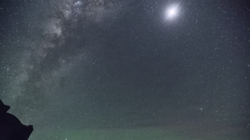 Stunning night sky with Milky Way galaxy and bright moon creating dramatic celestial scene perfect for astronomy and nature photography projects.