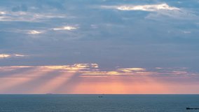 Dramatic sunbeams breaking through cloudy sky over calm ocean at sunset, creating divine rays of light illuminating the peaceful seascape horizon. - Powered by Shutterstock - Get 15% off with code: PIKWIZARD15