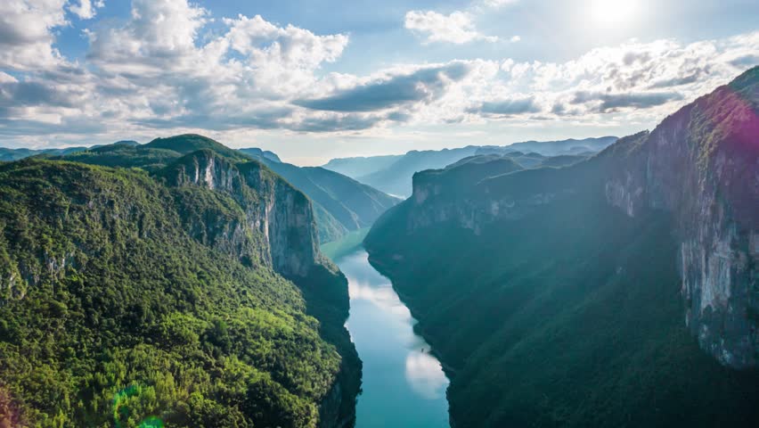 Stunning aerial view of Qingjiang River canyon with dramatic karst limestone cliffs and lush green vegetation, tributary of the Yangtze River in China
