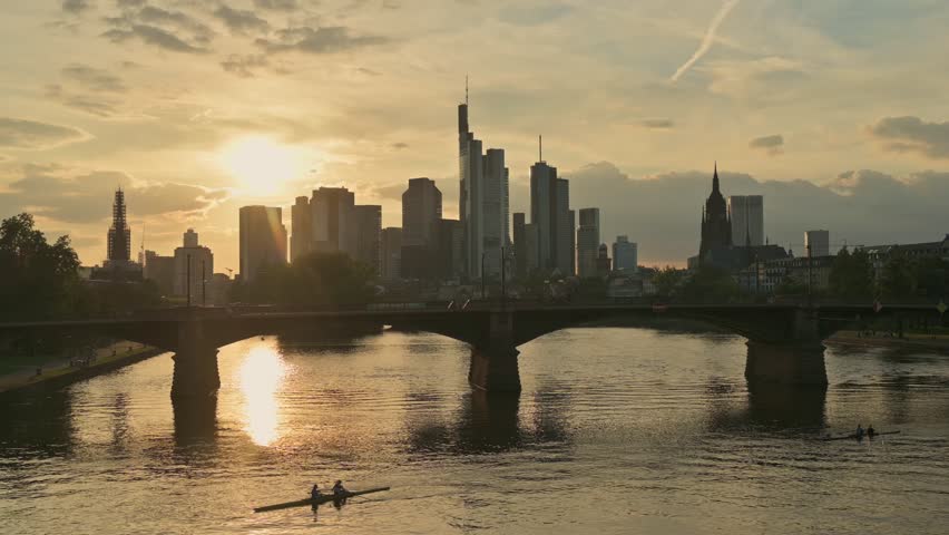Skyline of Frankfurt am Main with Skyscrapers Reflected in the Golden Main River – Germany	