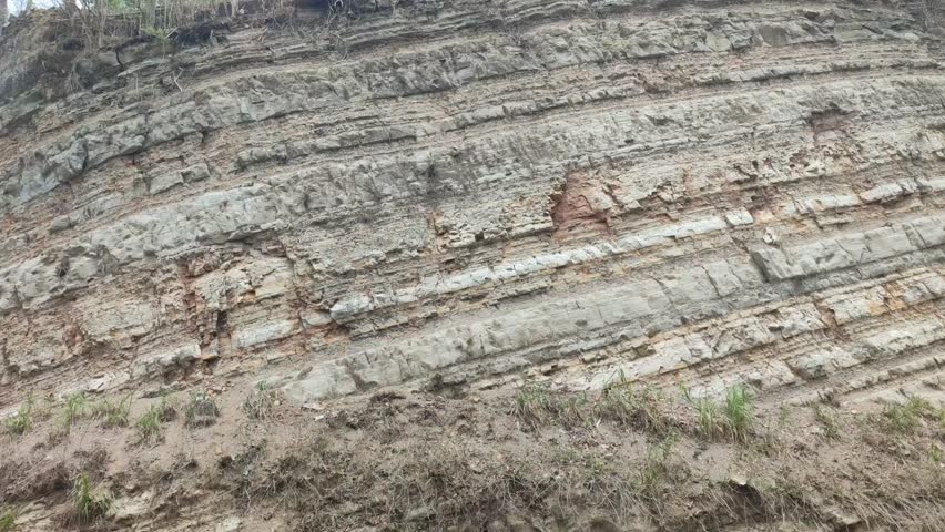 a section of a hill where the soil layer is visible