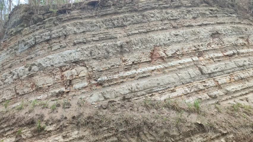 a section of a hill where the soil layer is visible