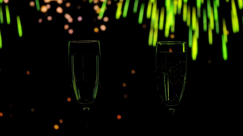 Two glasses of champagne with golden bubbles against a backdrop of warm bokeh fireworks. A festive mood for New Year