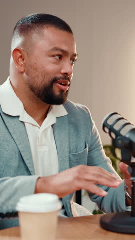 Podcast, talking or man in studio with microphone, discussion or personal story in streaming show. Broadcast, digital or influencer in booth with equipment, announcement or sharing idea in chat.