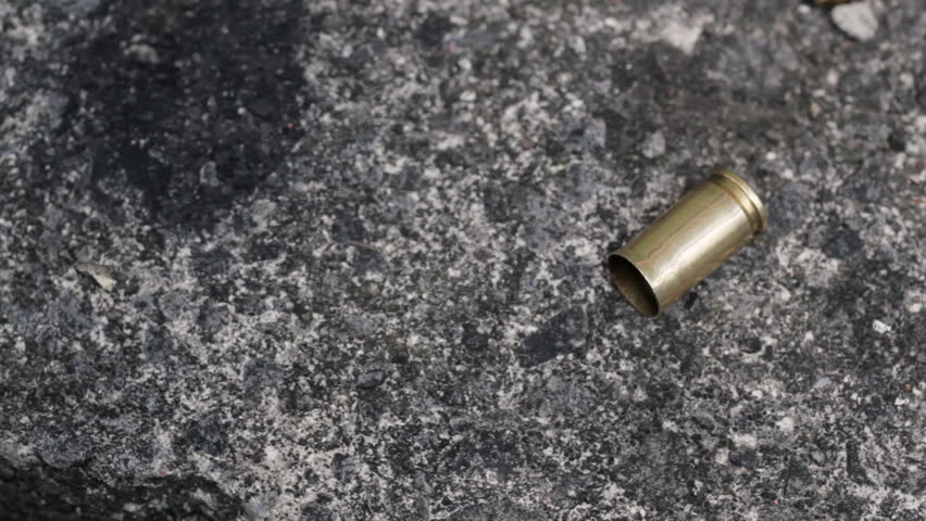 Picking spent bullet from crime scene