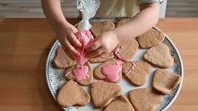 Little toddler girl decorating heart-shaped cookies with pink frosting. Ultra HD 4K video footage
 - Powered by Shutterstock - Get 15% off with code: PIKWIZARD15
