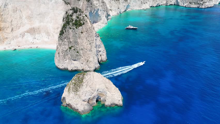Aerial drone cinematic video from scenic viewpoint to small iconic islets of Mizithres a true paradise tourist place visited by yachts and sail boats in island of Zakinthos, Ionian Sea, Greece