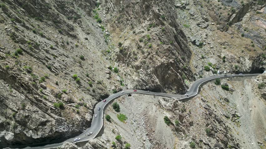 Dangerous mountain roads in arid Hindu Kush mountains bordering Pakistan, drone aerial