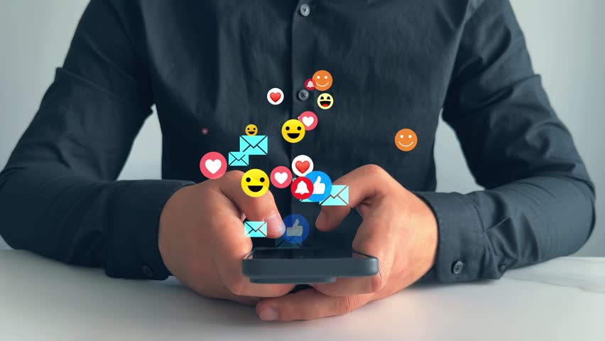 Interactive with friends on chat with emoticon feedback.Social media,marketing, like,social network,blog,live,chat reaction and livestream.Person using smart phone with emoticon icons of Social Media.
