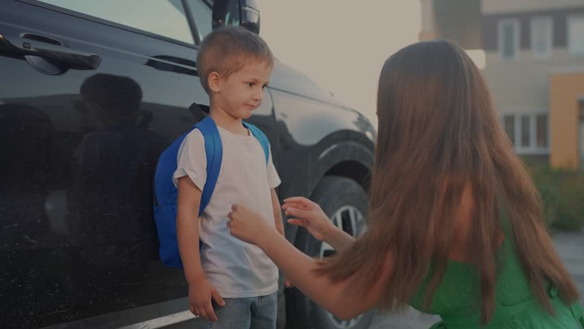 Back to school. Mom meets her son at school. Child mother family concept. Mom brings her boy son back to school. Mom returns her son to school. lifestyle education concept.