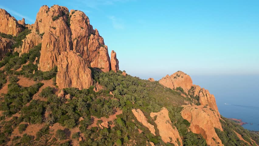 Panoramic aerial view of Esterel Mountains red cliffs overlooking the Mediterranean Sea, French Riviera, Southern France – dramatic mountain landscape and scenic coastline