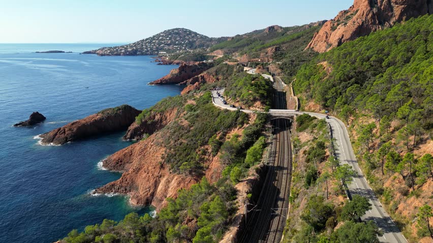 Aerial view of Esterel Mountains and winding coastal road above the blue Mediterranean Sea, French Riviera, France