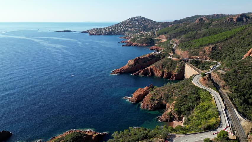 Aerial view of Esterel Mountains and winding coastal road above the blue Mediterranean Sea, French Riviera, France