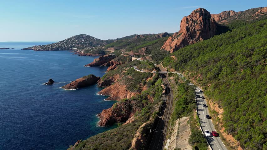 Aerial view of Esterel Mountains and winding coastal road above the blue Mediterranean Sea, French Riviera, France