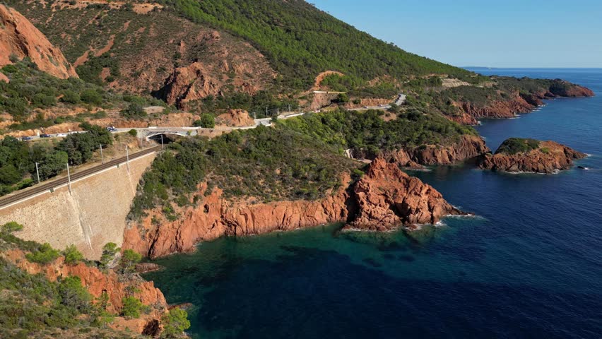 Aerial view of Esterel Mountains and winding coastal road above the blue Mediterranean Sea, French Riviera, France