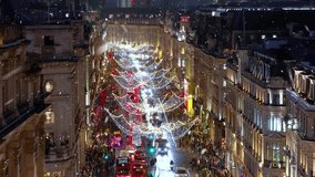 Christmas in London concept with decorated, festive shopping streets in the city center and snow falling during night time - Powered by Shutterstock - Get 15% off with code: PIKWIZARD15