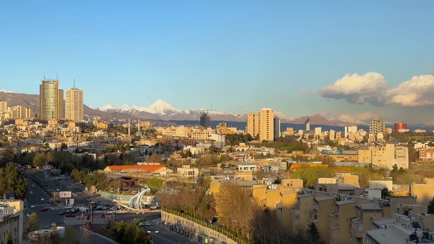 Tehran urban view of Azadi Tower landmark iconic architecture modern cityscape mountains skyline sunset sky Milad Tower Iran tourism culture historic Persian monument Middle East travel attraction